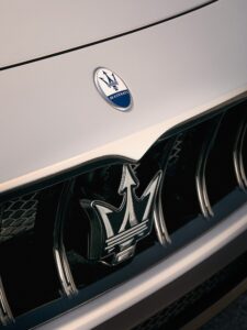Maserati grecale SUV extreme close up showing signature grill frame and trident logo above and on the grille