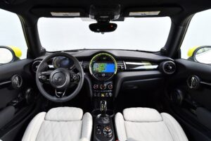 mid shot of front passenger seats, steering wheel and infotainment sreen in the new 2022 mini electric