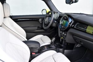 side view of front passenger seats, steering wheel and infotainment screen in the new 2022 mini electric