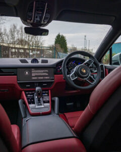 2022 Porsche Cayenne SUV interior. Red and Black Leather
